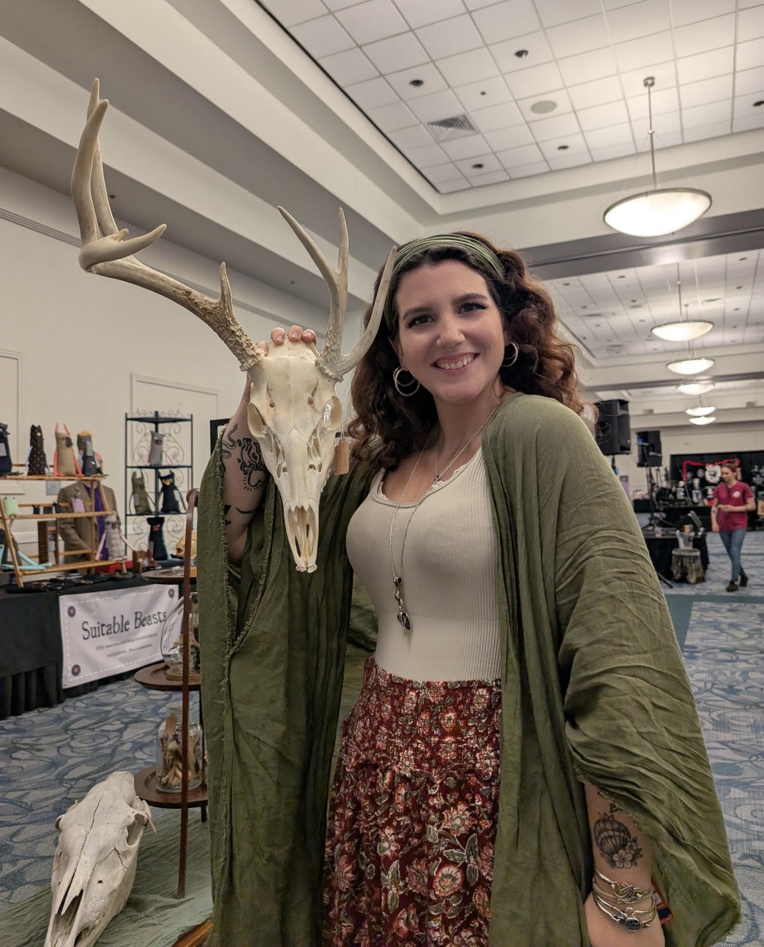 Member of the Earth Pulled Eulogies family holding an antlered skull at an event